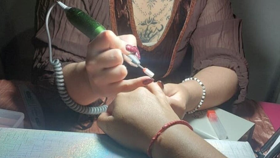Nail technician perfecting manicure at Jax_morningstar_nails, Libertad, Provincia De Buenos Aires, AR.