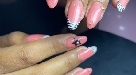 Intricate nail art design at Monate Center Spa, San Pedro Tlaquepaque, Jalisco, MX featuring coral polish and patterns.