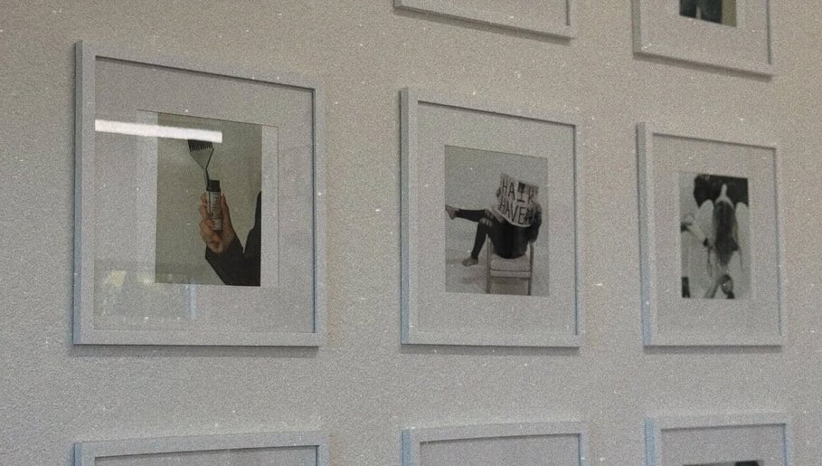 Stylish framed photos on wall at Blondes by Lily, Englewood, Florida, US, showcasing hair art and creativity.