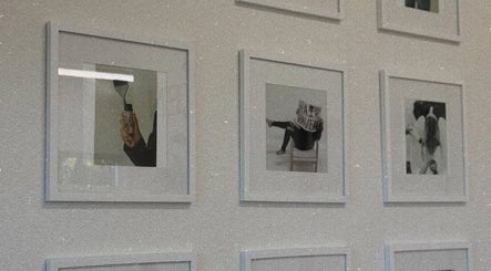 Stylish framed photos on wall at Blondes by Lily, Englewood, Florida, US, showcasing hair art and creativity.