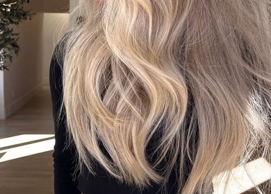 Flowing blonde hair styled at Blondes by Lily, Englewood, Florida, US in a serene salon setting.