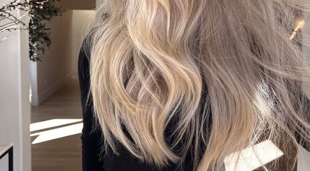 Flowing blonde hair styled at Blondes by Lily, Englewood, Florida, US in a serene salon setting.