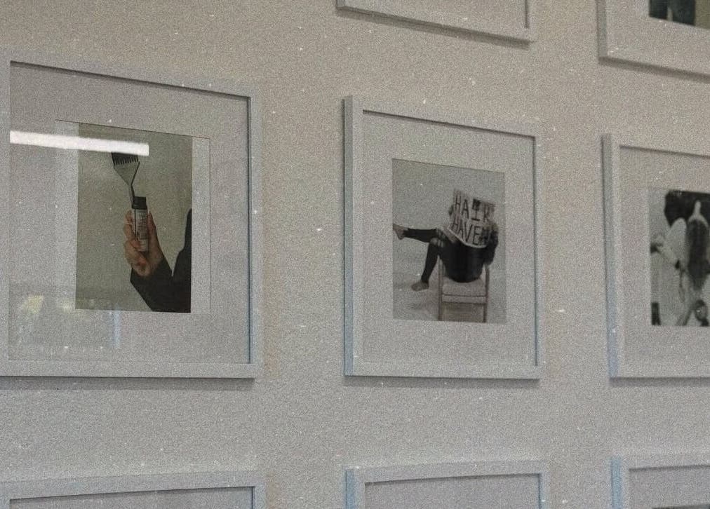 Gallery wall decor at Blondes by Lily, Englewood, Florida, US featuring framed creative posters.