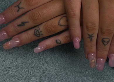 Stylish pink acrylic nails with tattoos at Bhadnpolishedd, Crestmead, Queensland, AU.