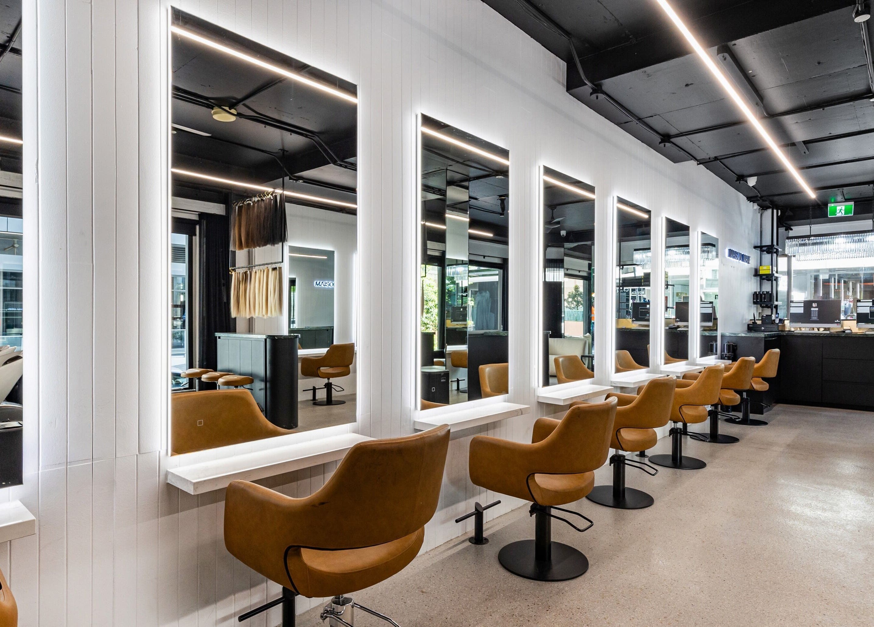 Interior view of MAISON MANE HAIR salon in Bondi Junction, New South Wales, AU showcasing modern seating and mirrors.