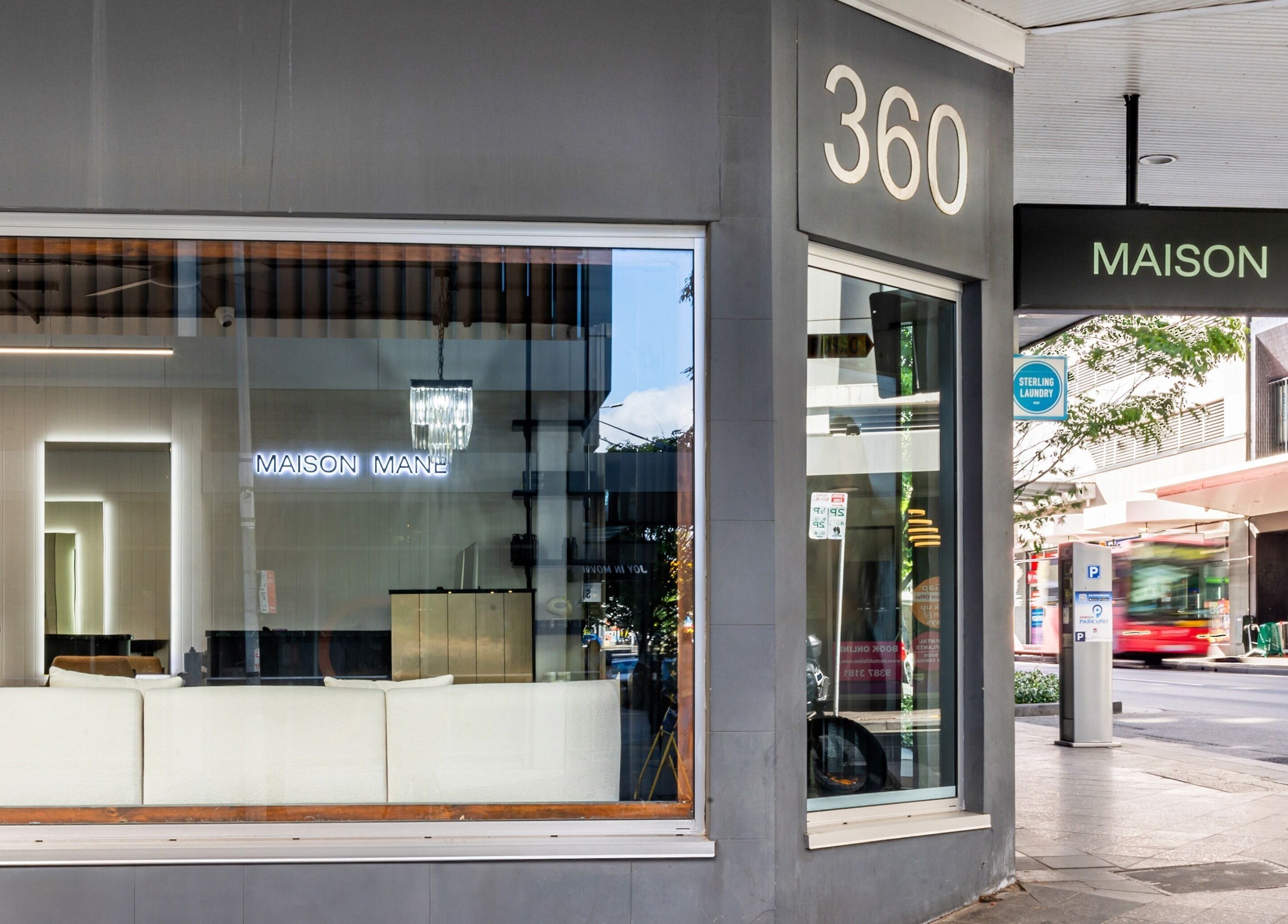 Exterior view of MAISON MANE HAIR at Bondi Junction, New South Wales, AU showcasing a sleek salon window.