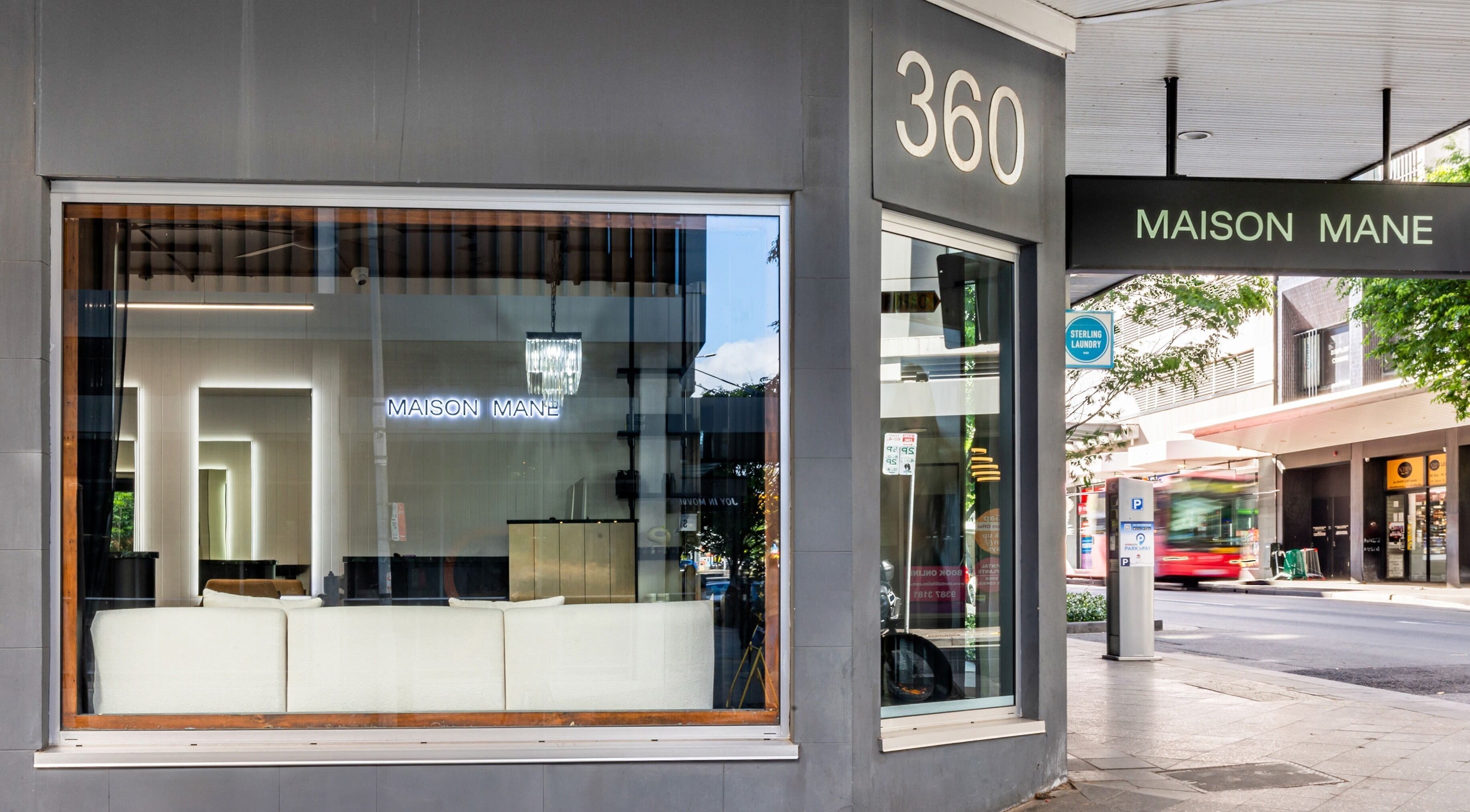 Exterior view of MAISON MANE HAIR at Bondi Junction, New South Wales, AU showcasing a sleek salon window.
