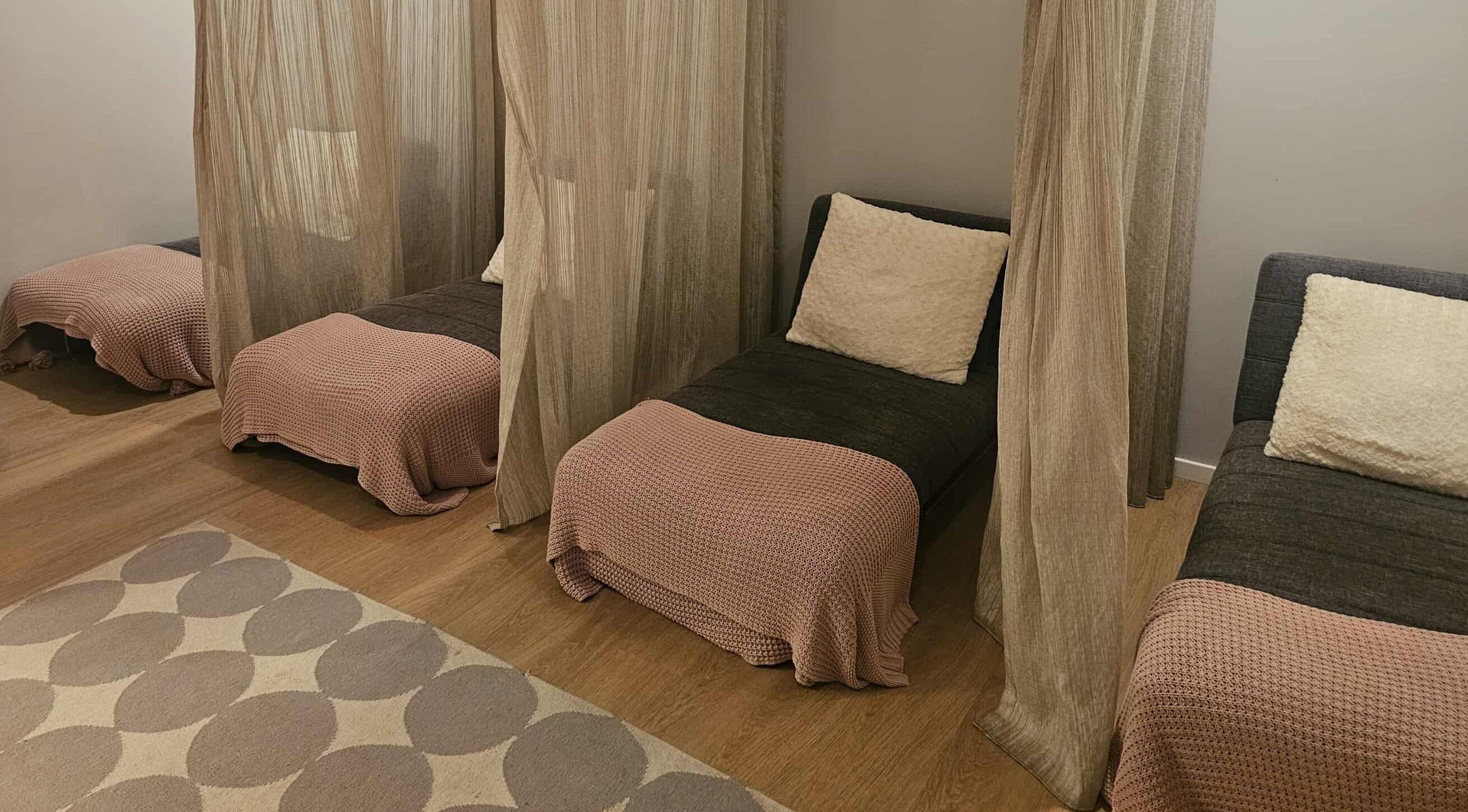 Cozy relaxation area at Haylo Skin & Body in Wellington, Wellington Region, NZ, featuring plush seating and soft drapes.