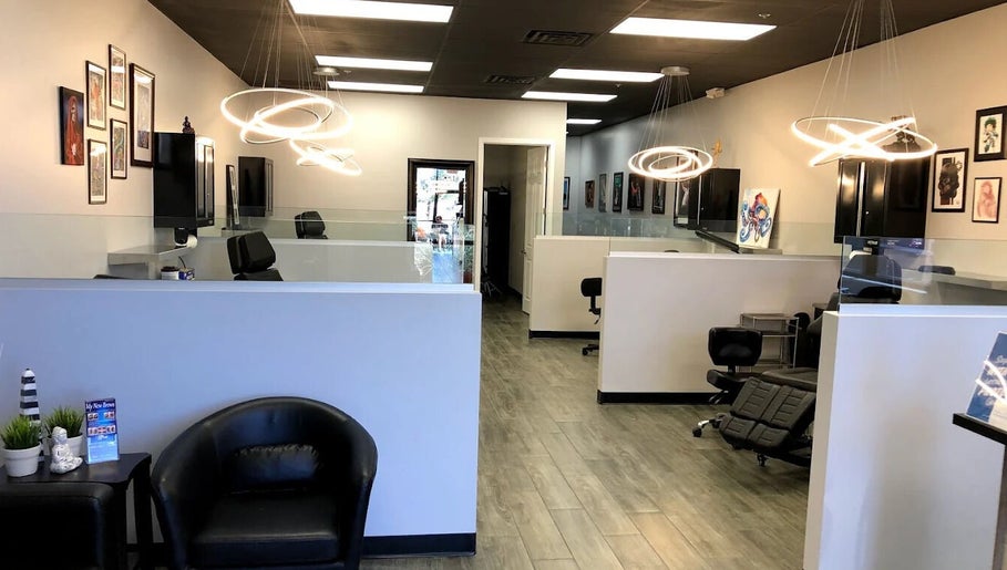 Modern interior of The Tattoo Lounge in Mesa, Arizona, US with stylish lighting and artwork on display.