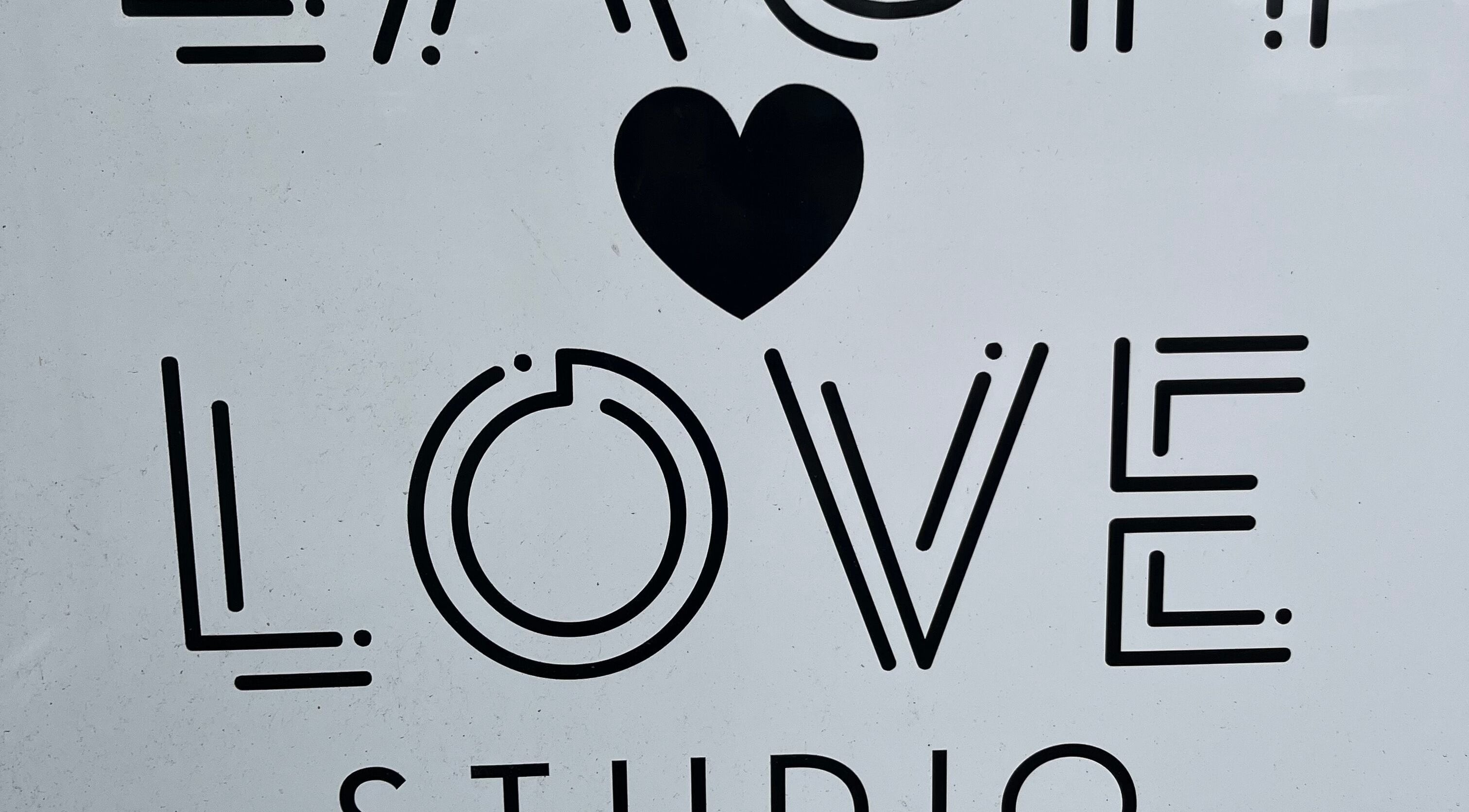 Bold 'LOVE' signage with heart at ByNataliemaria, Bromborough, England, GB.