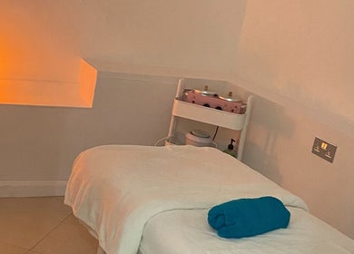 Peaceful massage room at Chelsea Beauty, London, England, GB with warm lighting and cozy setting.