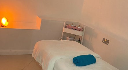 Peaceful massage room at Chelsea Beauty, London, England, GB with warm lighting and cozy setting.