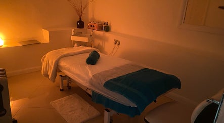 Massage room at Chelsea Beauty, London, England, GB with a lit, tranquil ambiance.