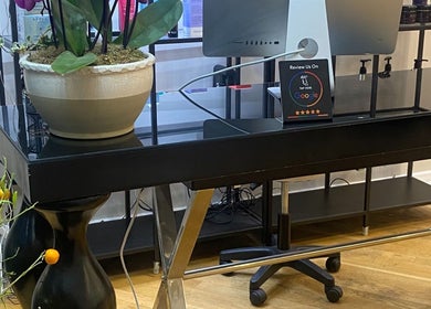 Reception desk at Chelsea Beauty, London, England, GB featuring a sleek design and a vibrant plant display.
