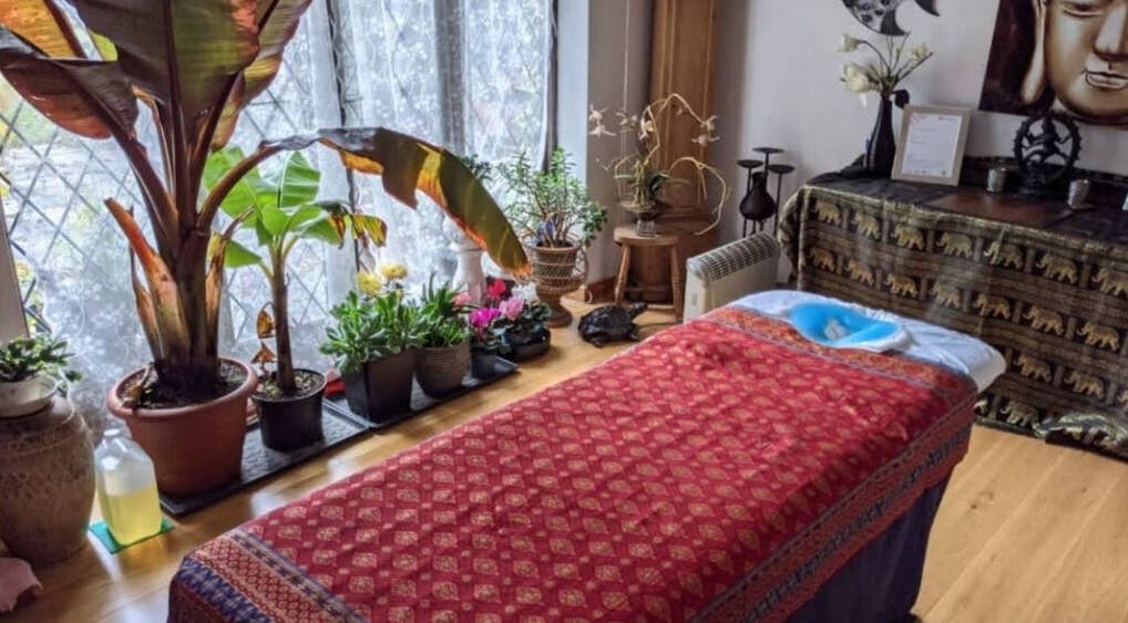 Relaxing therapy room at Sabai Sabai Thai Therapy in Oxted, England, GB with plants and massage bed.