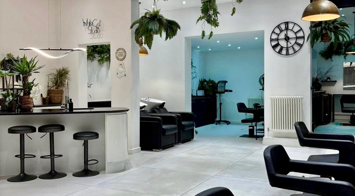 Contemporary salon interior at LA Hair, White Cat Studio, Cardiff, Wales, GB, featuring stylish chairs and decor.