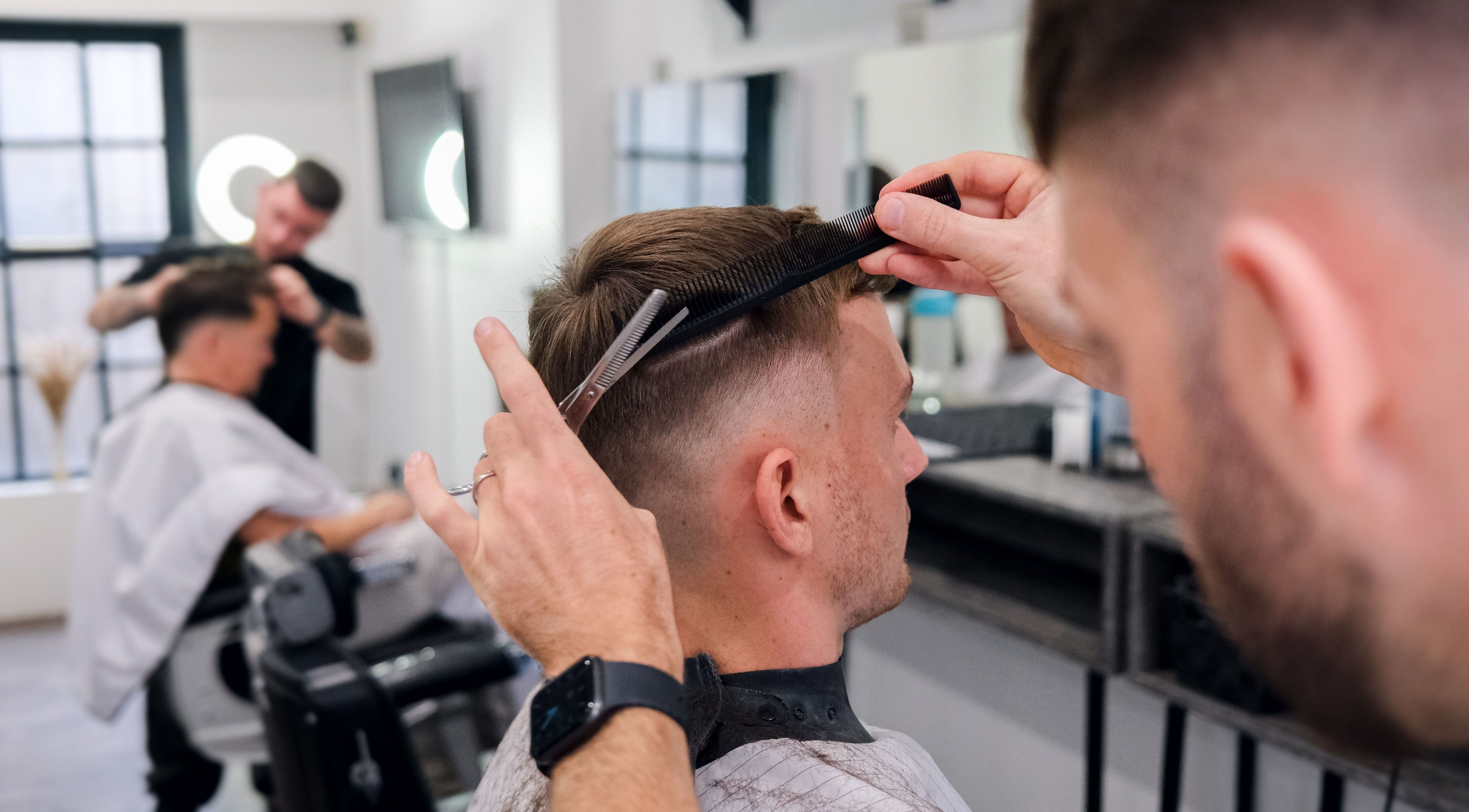 Stylist at Prestige Salon in Lancaster, England, GB, perfecting a modern men's haircut in a chic setting.
