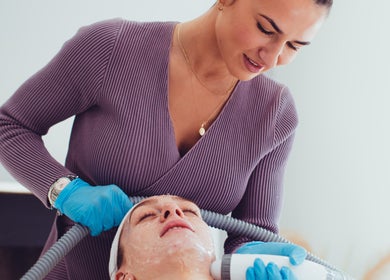 Aesthetician performing facial treatment at Prestige Salon, Lancaster, England, GB, enhancing skin radiance.