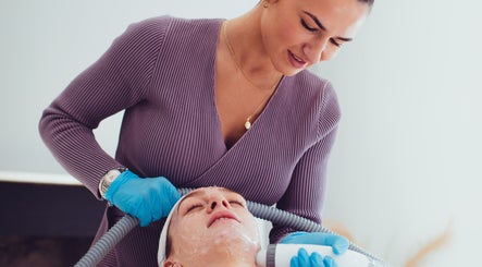 Aesthetician performing facial treatment at Prestige Salon, Lancaster, England, GB, enhancing skin radiance.