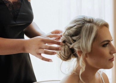 Stylist crafting elegant updo at Larose Hair Studio, High Wycombe, England, GB.