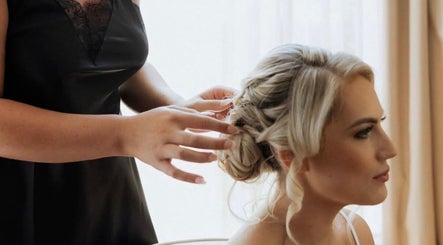 Stylist crafting elegant updo at Larose Hair Studio, High Wycombe, England, GB.