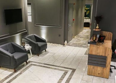 Modern lobby at Let's Relax Royal Galata Spa & Turkish Bath, İstanbul with cozy seating and reception desk.