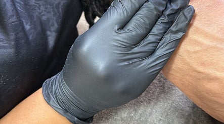 Gloved hand providing therapeutic treatment at Bella Escape Beauty Salon, Willemstad, CW for a rejuvenating experience.