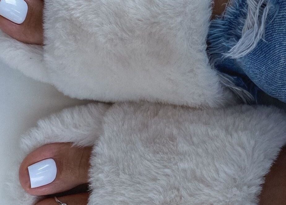 Fluffy slippers with polished toes at Bella Escape Beauty Salon, Willemstad, CW offering luxury foot care.