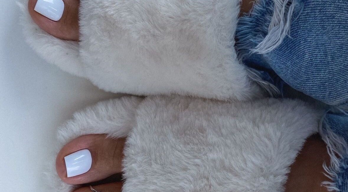 Fluffy slippers with polished toes at Bella Escape Beauty Salon, Willemstad, CW offering luxury foot care.