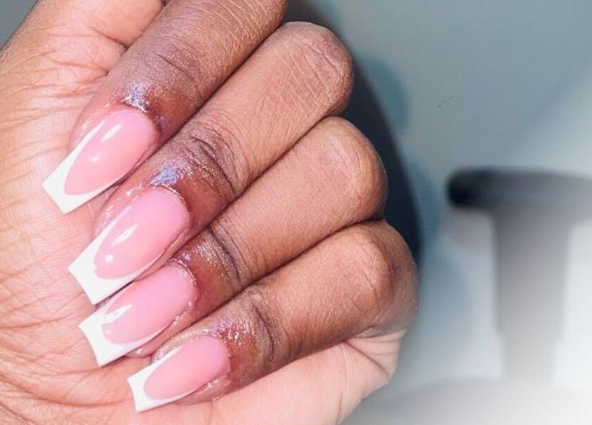 Close-up of French manicure at Bella Escape Beauty Salon, Willemstad, CW, showcasing elegant nail design.