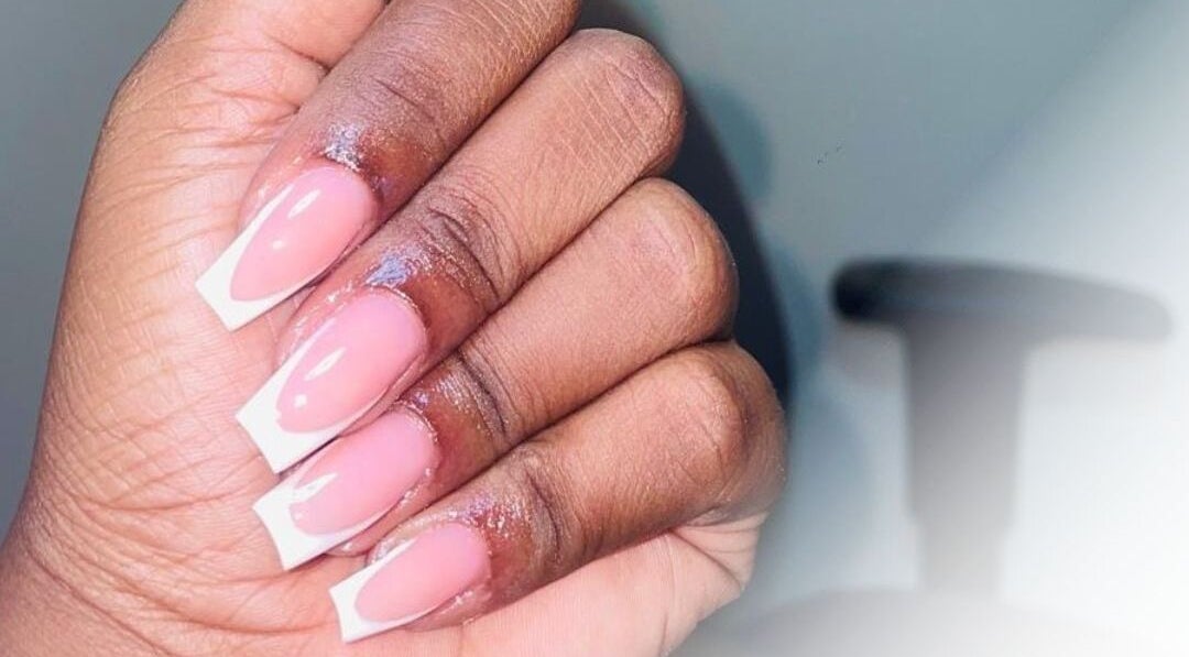 Close-up of French manicure at Bella Escape Beauty Salon, Willemstad, CW, showcasing elegant nail design.