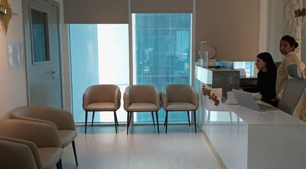 Reception area of Meta Poly Clinic in دبي, دبي, AE featuring cozy seating and modern decor.