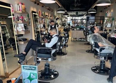 Modern barbershop setup at Wakar Al Chaib, Riyadh, Riyadh Province, SA, featuring stylish seating and grooming tools.