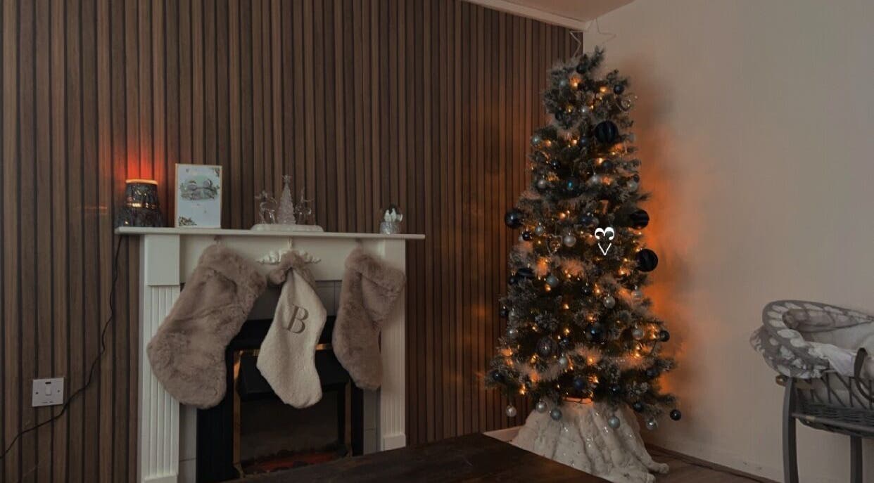 Elegant holiday setup at LF Beautyy in Dundonald, Northern Ireland, GB with a lit Christmas tree and decorated mantel.