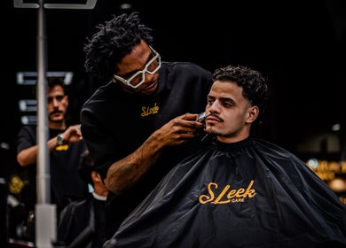 Barber perfecting a hairstyle at Sleek Care, Riyadh, Riyadh Province, SA for a stylish look.