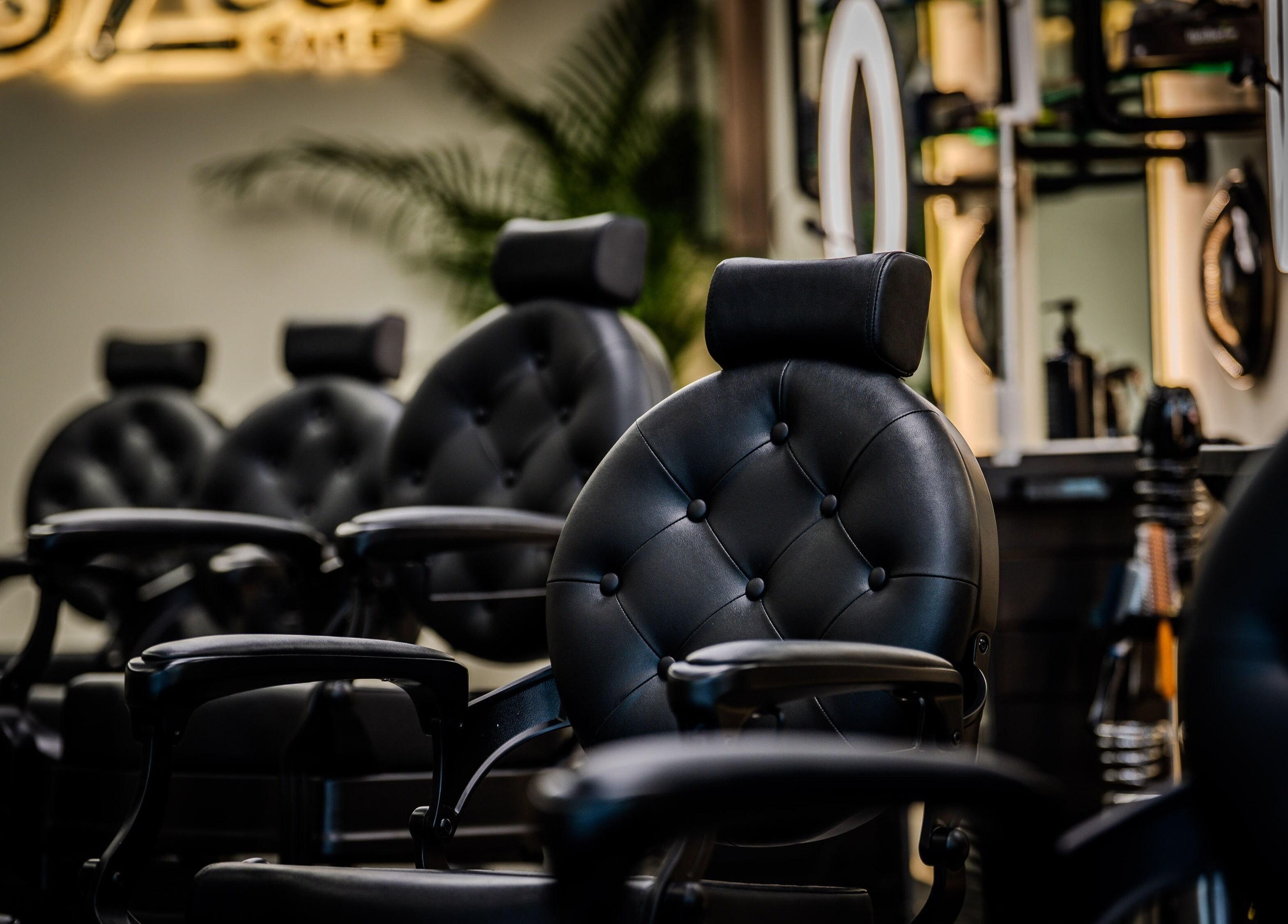 Elegant black salon chairs at Sleek Care, Riyadh, Riyadh Province, SA offering premium beauty services.