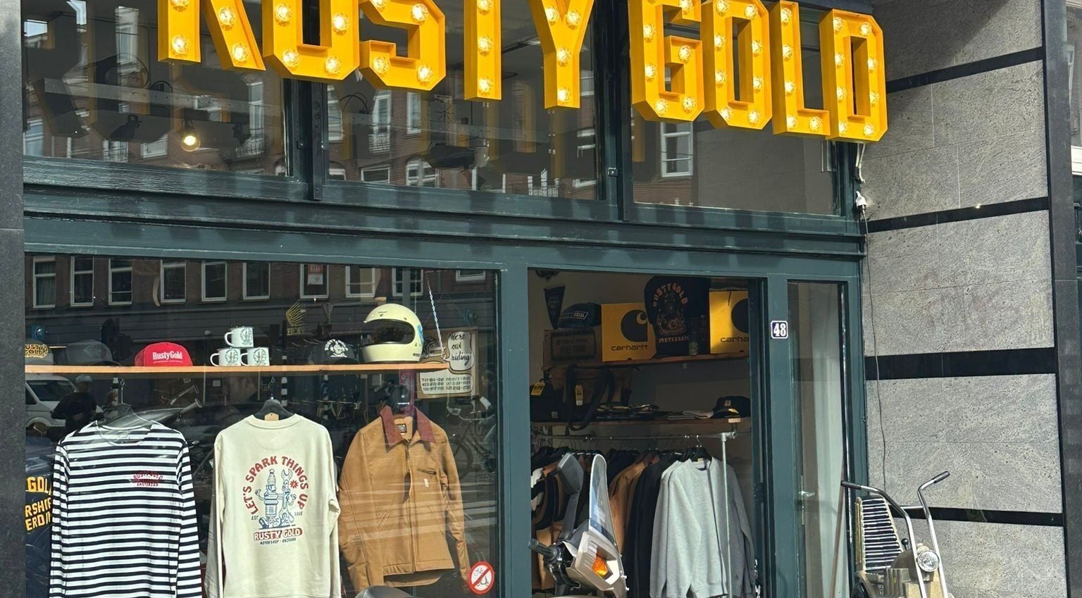 Exterior of The Wolf Barber Shop, Amsterdam, Noord-Holland, NL, showcasing stylish apparel and accessories.