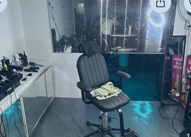 Modern barber chair at Payso Cuts, New York, New York, US, surrounded by stylish salon tools.