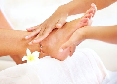 Foot massage at D'Luxe Touch in Freeport, Freeport, BS, providing a serene wellness experience.