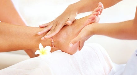 Foot massage at D'Luxe Touch in Freeport, Freeport, BS, providing a serene wellness experience.