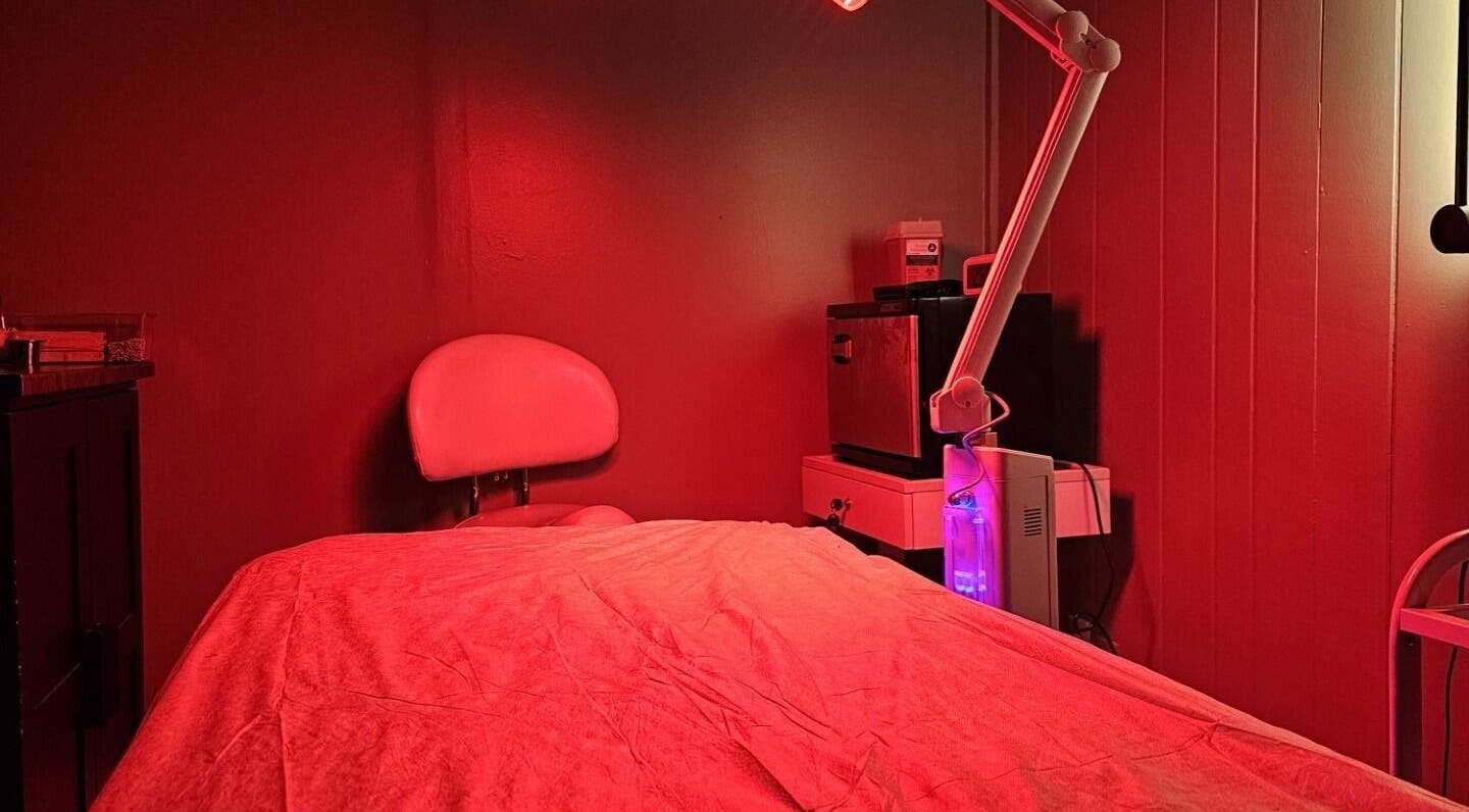 Red-lit therapy room at The Sculpting Art Day Spa in Hendersonville, TN, US, offering relaxation and wellness.