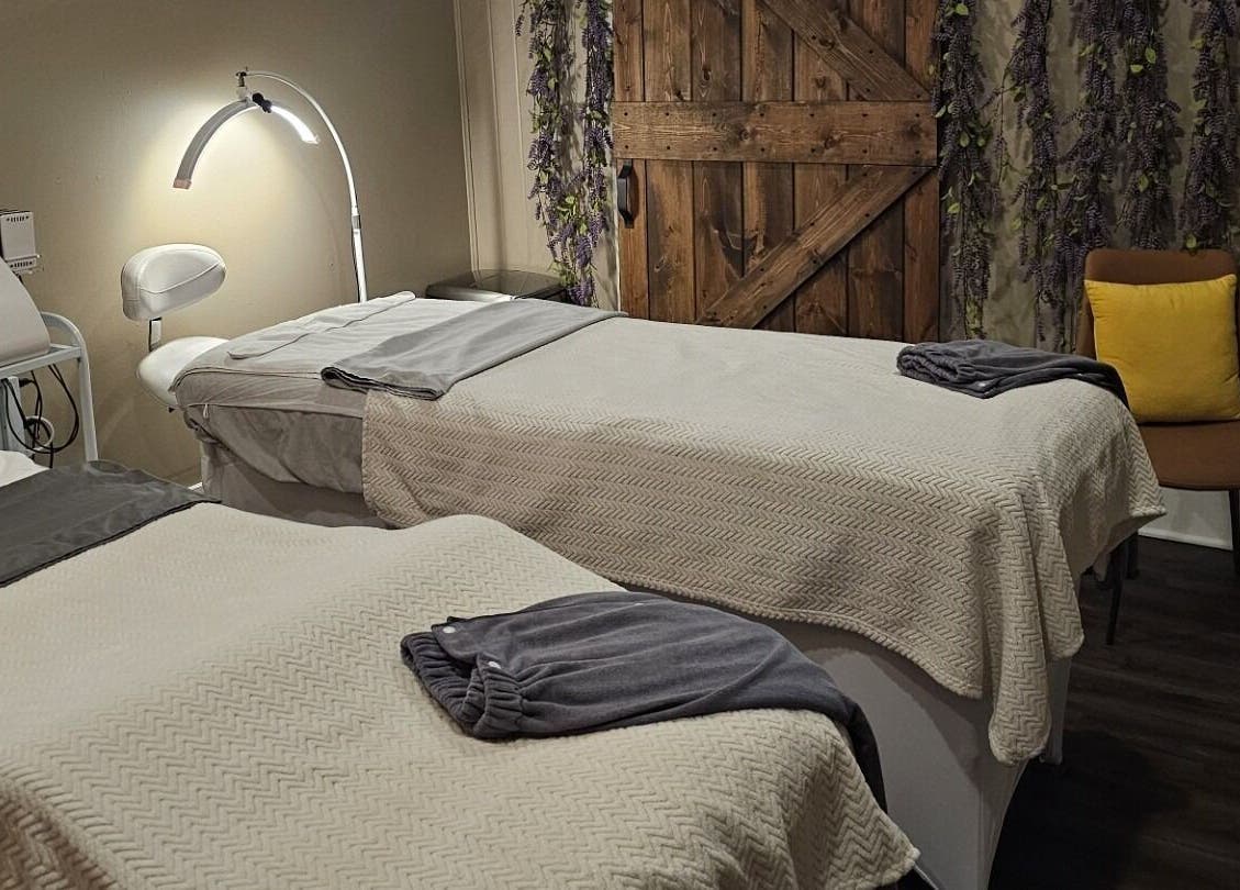 Cozy treatment room at The Sculpting Art Day Spa, Hendersonville, TN, US, featuring two massage tables.