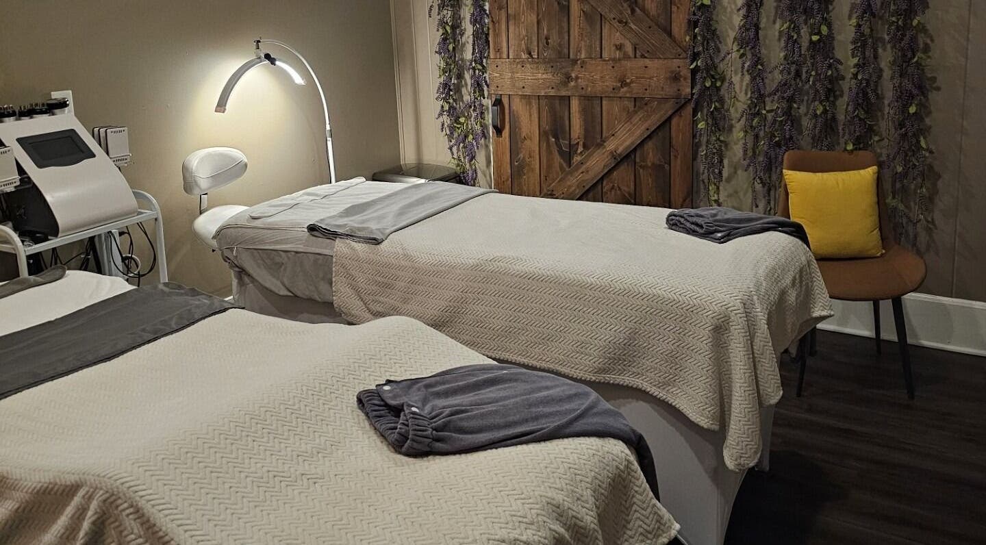 Cozy treatment room at The Sculpting Art Day Spa, Hendersonville, TN, US, featuring two massage tables.