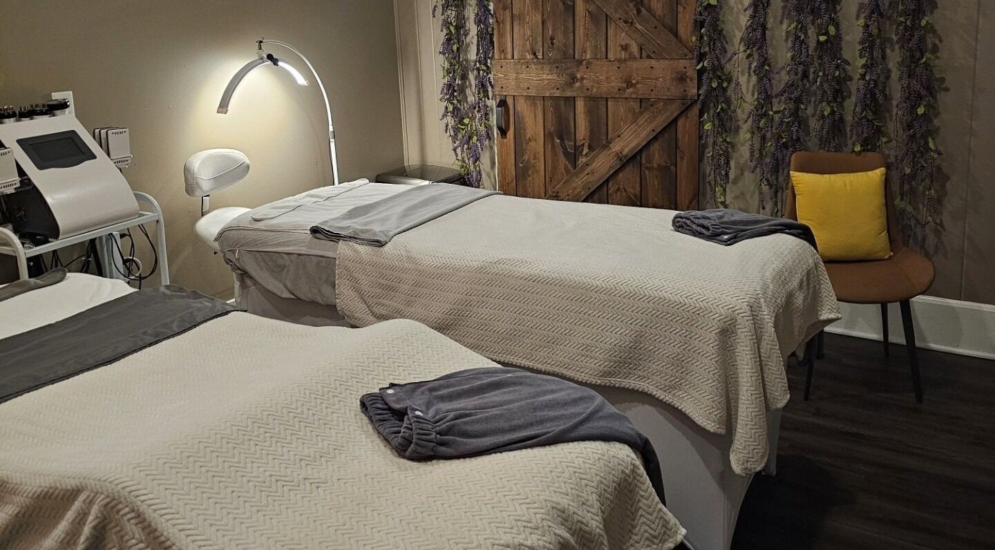Cozy treatment room at The Sculpting Art Day Spa, Hendersonville, TN, US, featuring two massage tables.