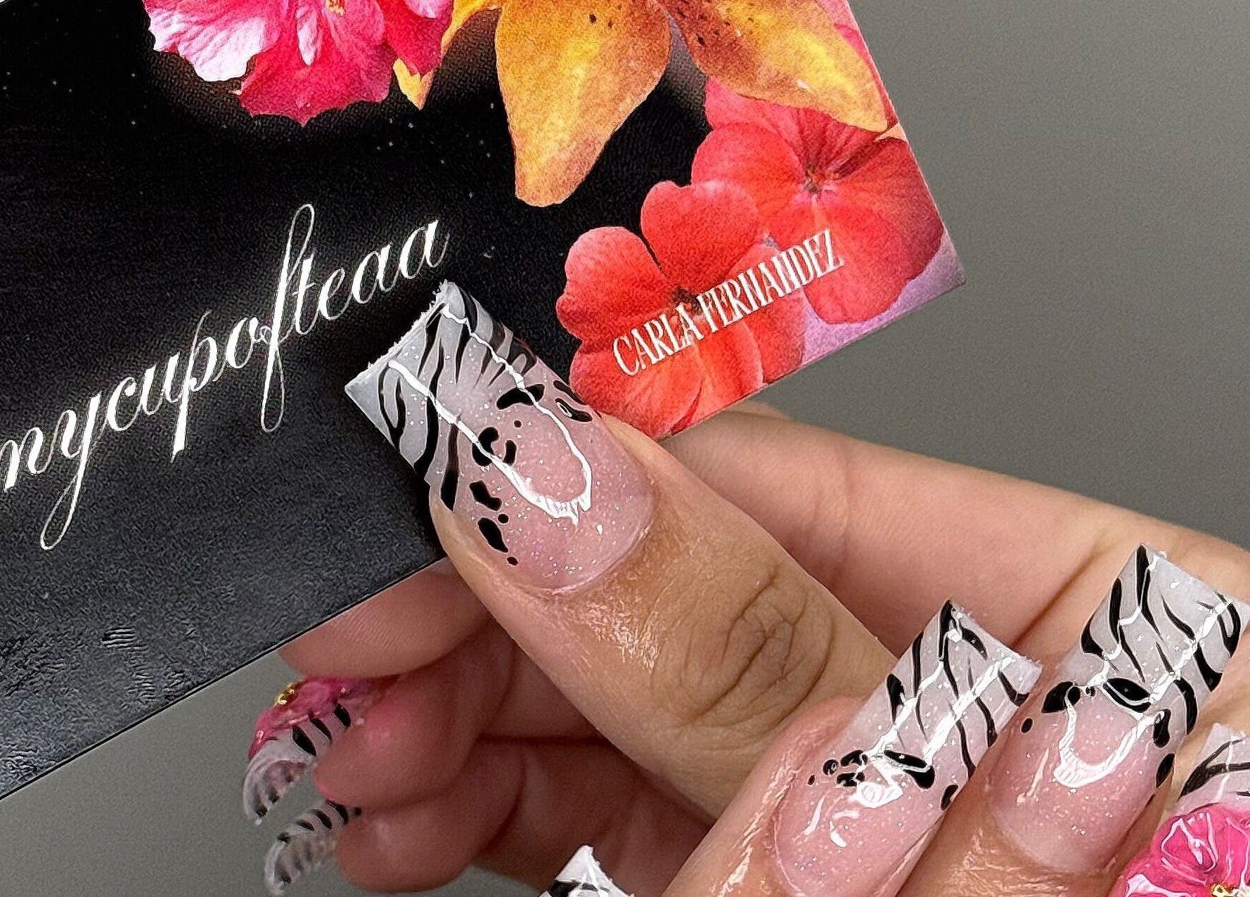 Elegant floral nail art at SHEMYCUPOFTEAA in Round Lake, Illinois, US showcasing unique zebra and flower design.