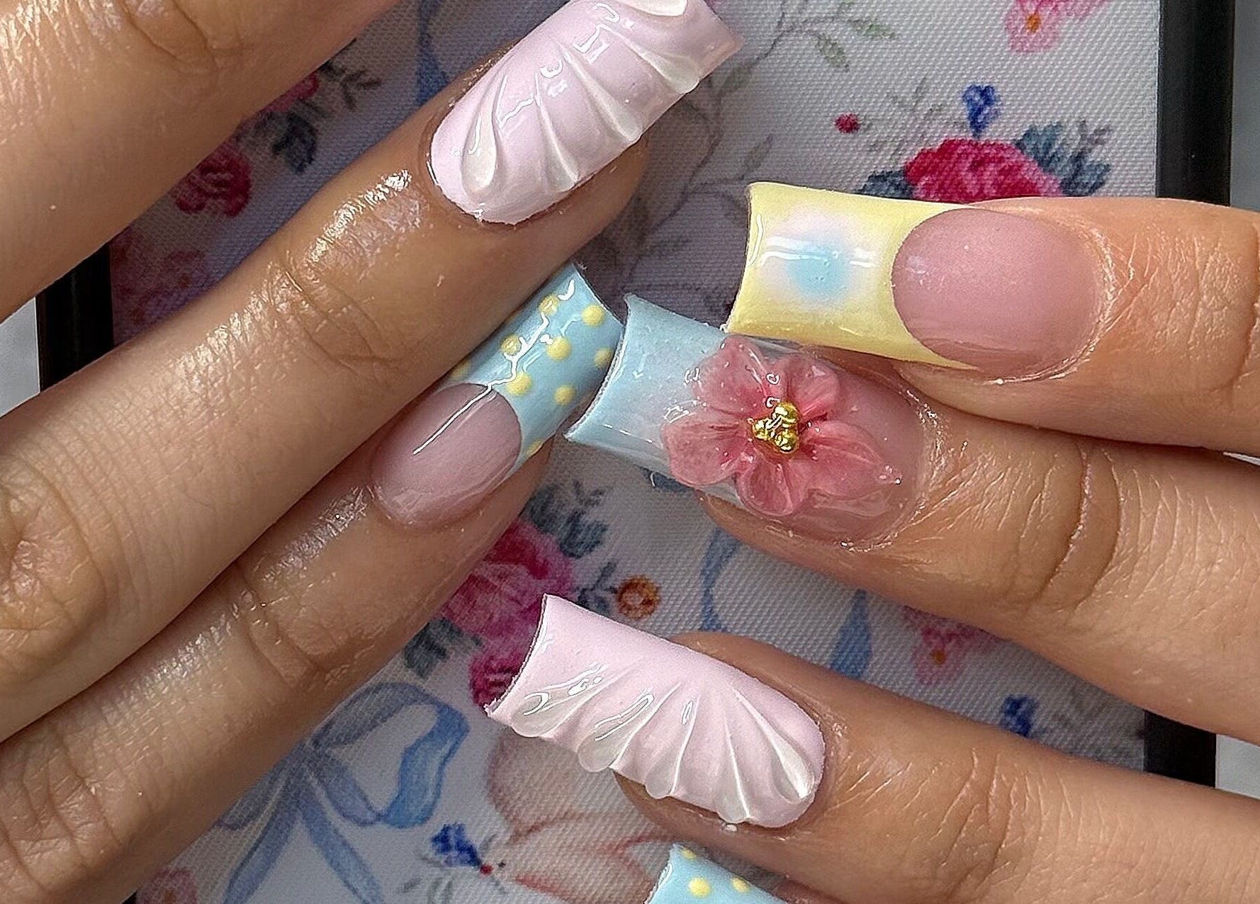 Exquisite nail art with floral designs at SHEMYCUPOFTEAA, Round Lake, Illinois, US.