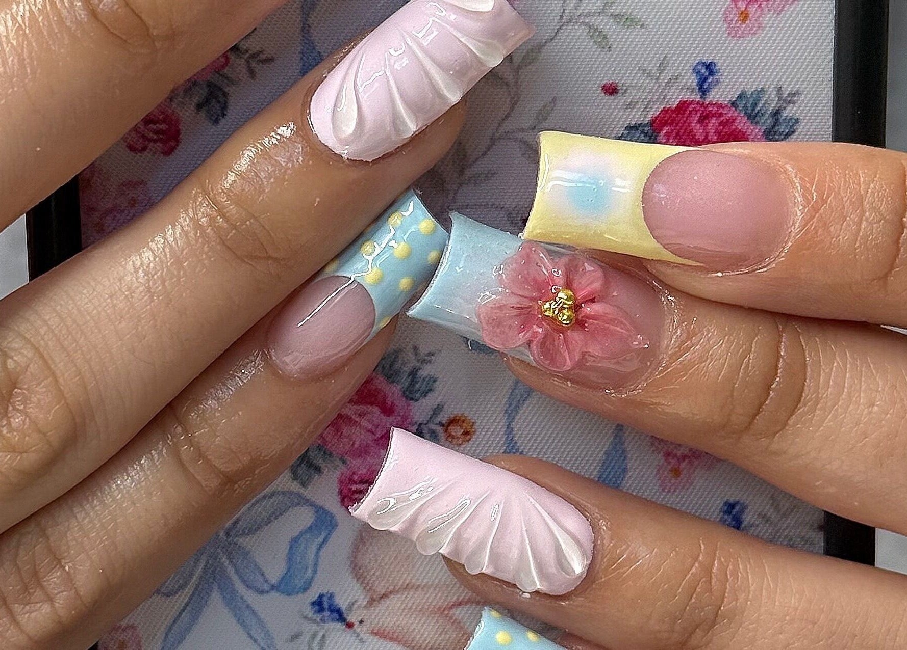 Exquisite nail art with floral designs at SHEMYCUPOFTEAA, Round Lake, Illinois, US.