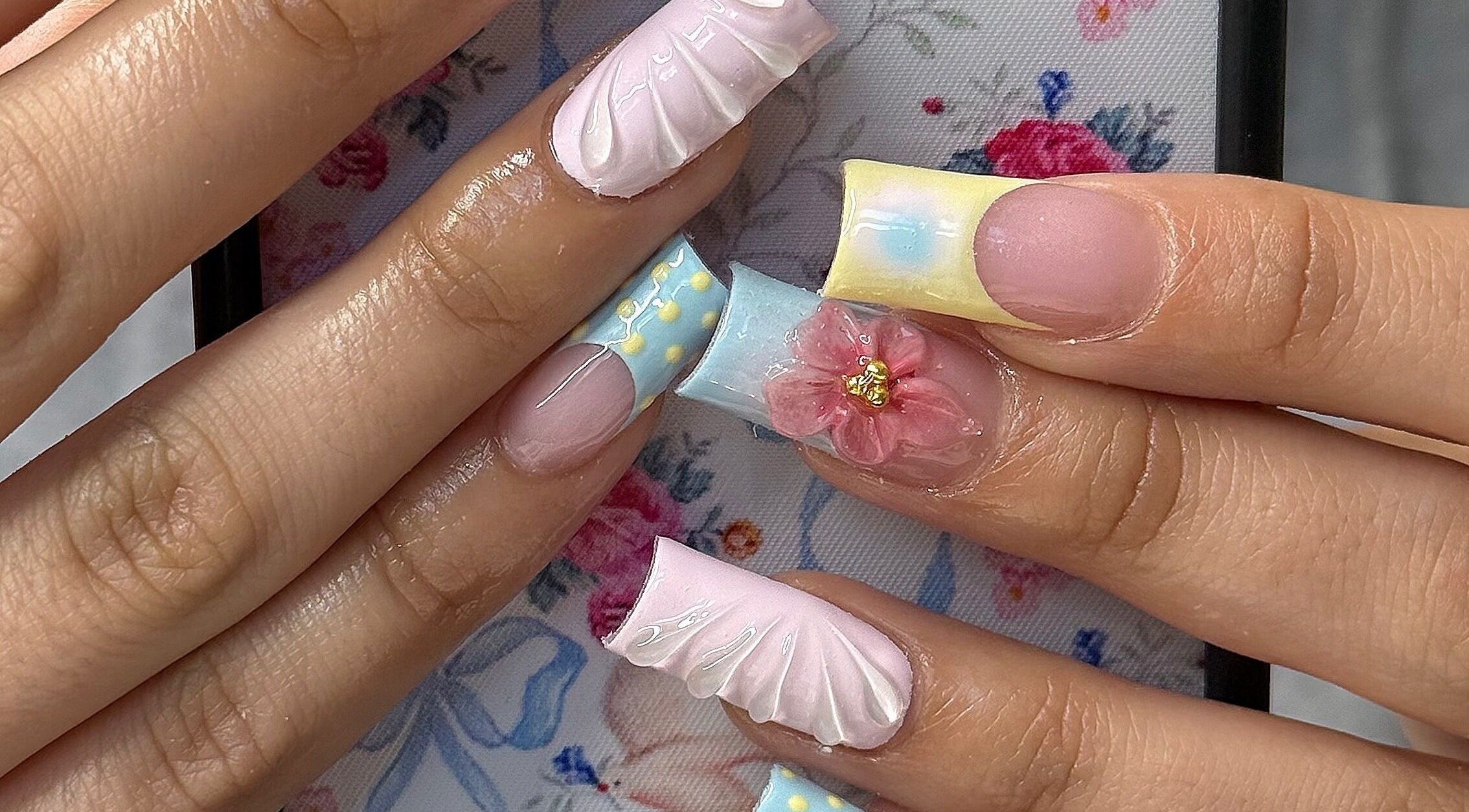 Exquisite nail art with floral designs at SHEMYCUPOFTEAA, Round Lake, Illinois, US.