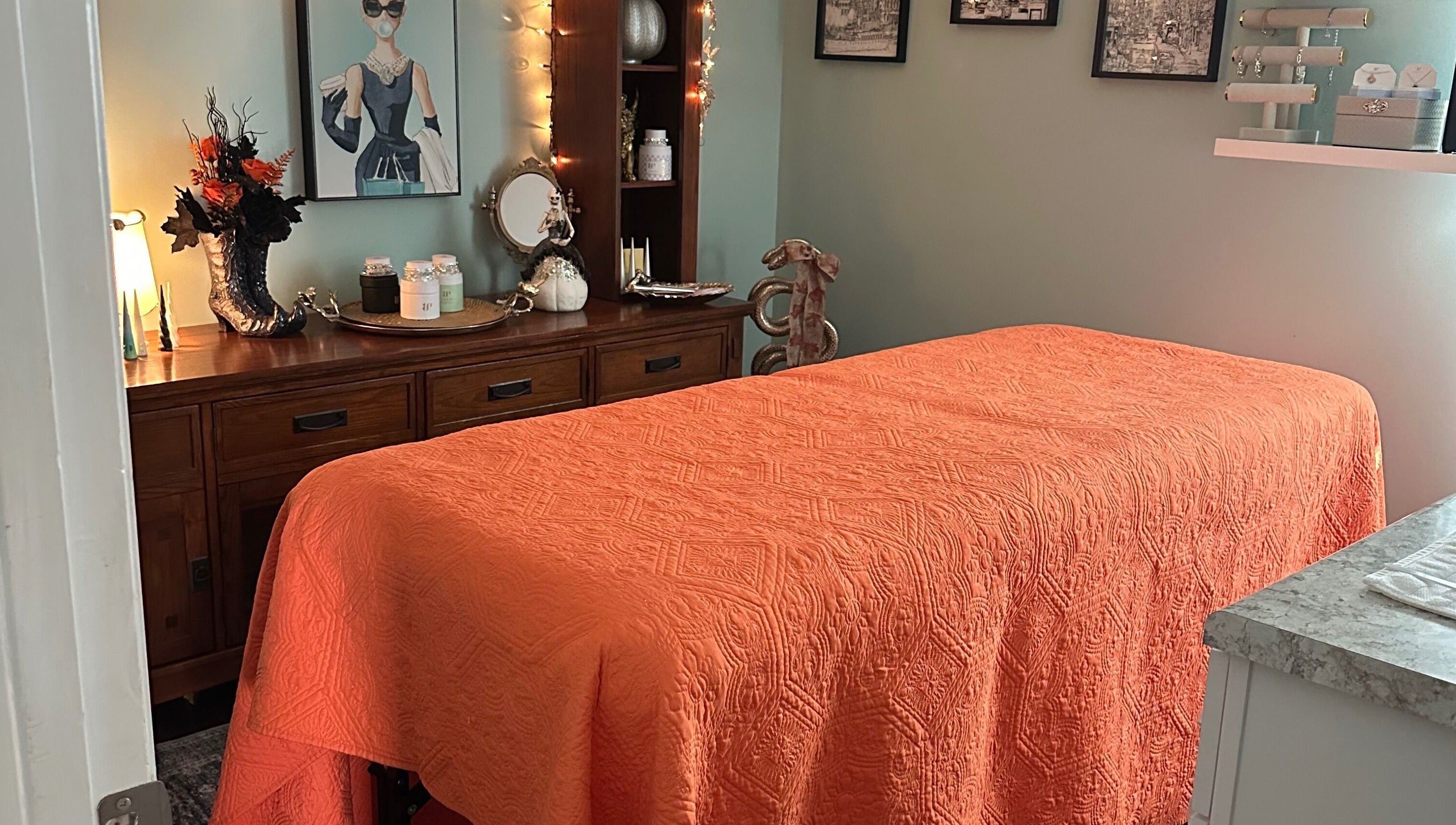 Tranquil massage room at Falling Waters Massage, Mad Lasher studio, Wilmington, NC, with orange decor.