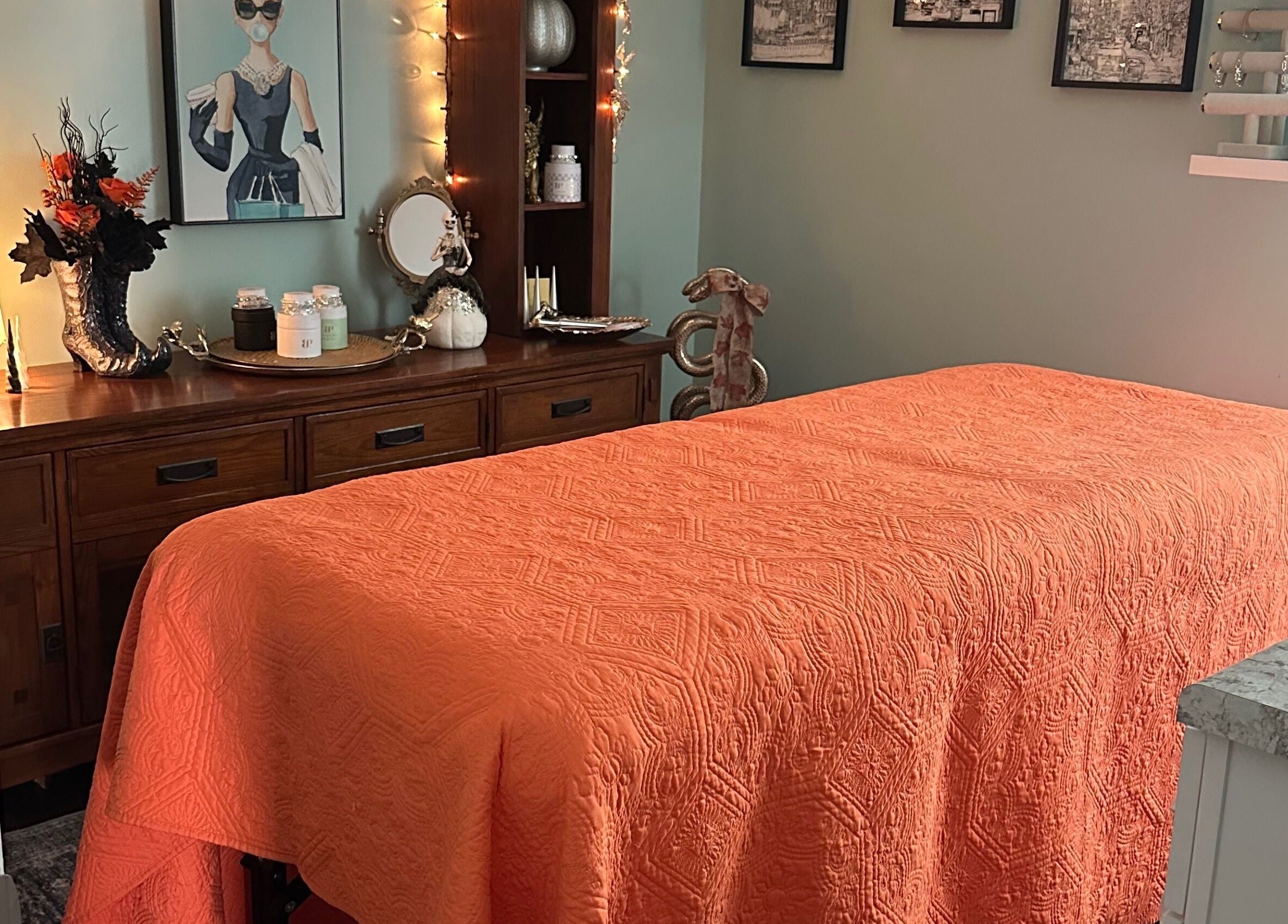 Tranquil massage room at Falling Waters Massage, Mad Lasher studio, Wilmington, NC, with orange decor.